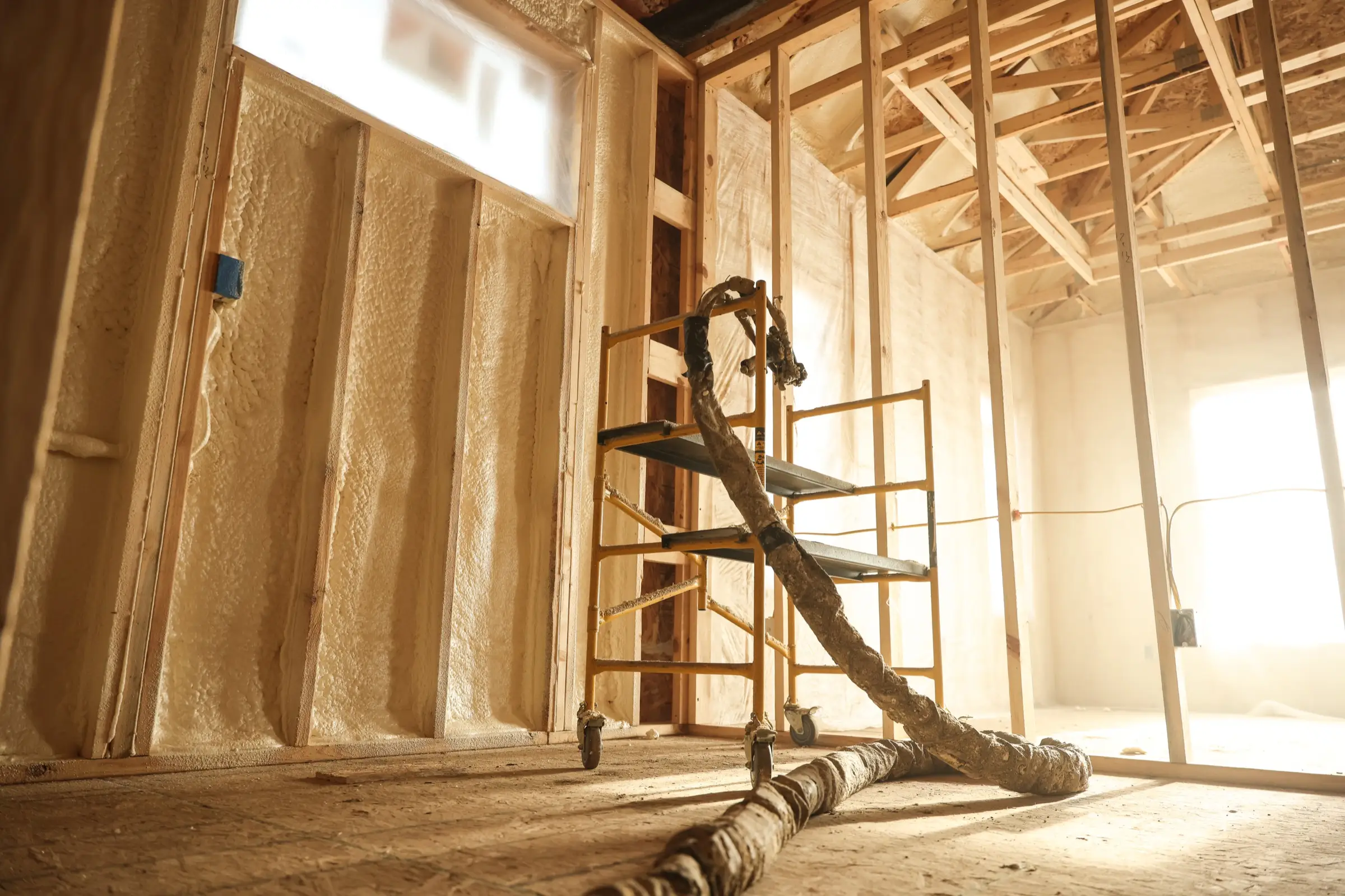 Installer applying metal building insulation with professional equipment