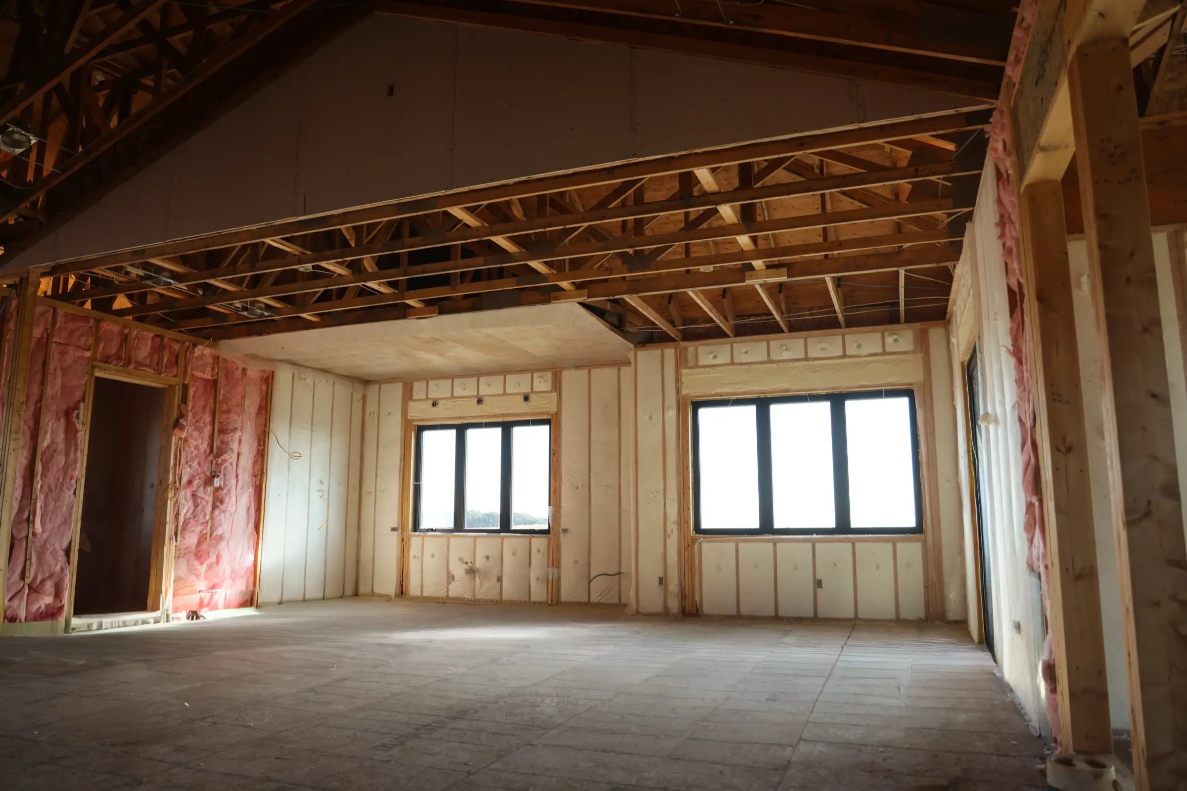 Professional installer applying metal building insulation in a Wichita building